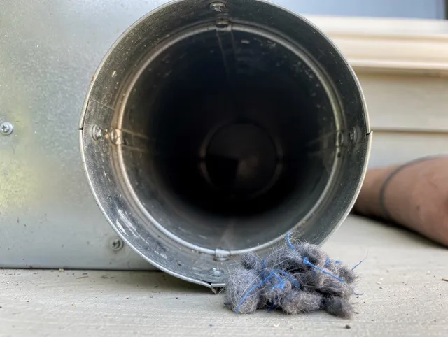 Compton Dryer Vent Cleaning technician using specialized equipment to clear severe dryer vent blockage in Compton